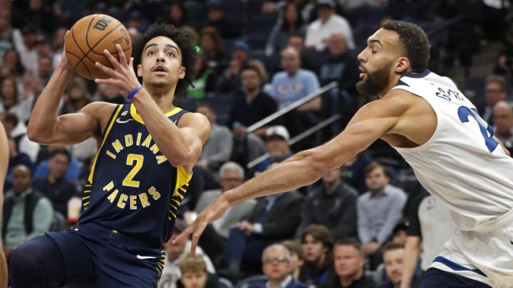 Dec 7, 2022; Minneapolis, Minnesota, USA; Indiana Pacers guard Andrew Nembhard (2) goes to the basket past Minnesota Timberwolves center Rudy Gobert (27) in the first quarter at Target Center. Mandatory Credit: Bruce Kluckhohn-USA TODAY Sports