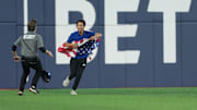 Oct 31, 2025; Toronto, Ontario, CAN; A  Baseball fan runs onto the players surface in the sixth inning for game six of the 2025 MLB World Series at Rogers Centre. Mandatory Credit: Nick Turchiaro-Imagn Images