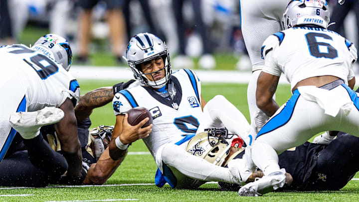 Sep 8, 2024; New Orleans, Louisiana, USA;  Carolina Panthers quarterback Bryce Young (9) is tackled as he scrambles out the pocket by New Orleans Saints cornerback Alontae Taylor (1) during the second half at Caesars Superdome. Mandatory Credit: Stephen Lew-Imagn Images