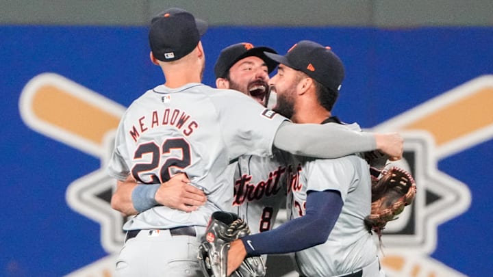 Sep 16, 2024; Kansas City, Missouri, USA; Three Detroit Tigers players celebrate a win on the outfield.