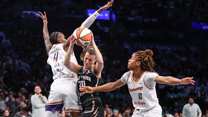 New York Liberty guard Sabrina Ionescu drives past Phoenix Mercury forward Natasha Mack and guard Monique Akoa Makani New York Liberty guard Sabrina Ionescu drives past Phoenix Mercury forward Natasha Mack and guard Monique Akoa Makani