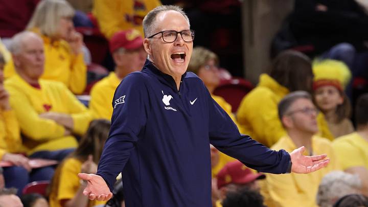Jan 11, 2026; Ames, Iowa, USA; West Virginia Mountaineers head coach Mark Kellogg watches his team play the Iowa State Cyclones during the first half at James H. Hilton Coliseum. Mandatory Credit: Reese Strickland-Imagn Images