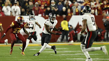 Dec 29, 2024; Landover, Maryland, USA; Atlanta Falcons tight end Kyle Pitts (8) catches a pass from Falcons quarterback Michael Penix Jr. (9) as Washington Commanders cornerback Michael Davis (24) defends during the fourth quarter at Northwest Stadium. Mandatory Credit: Geoff Burke-Imagn Images