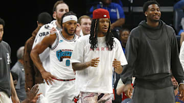 Apr 13, 2025; Memphis, Tennessee, USA; Memphis Grizzlies guard Ja Morant (left), forward Jaren Jackson Jr. (middle) and guard Desmond Bane (22) look on from the bench area during the second quarter against the Dallas Mavericks at FedExForum. Mandatory Credit: Petre Thomas-Imagn Images