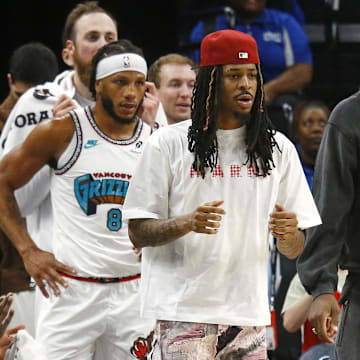 Apr 13, 2025; Memphis, Tennessee, USA; Memphis Grizzlies guard Ja Morant (left), forward Jaren Jackson Jr. (middle) and guard Desmond Bane (22) look on from the bench area during the second quarter against the Dallas Mavericks at FedExForum. Mandatory Credit: Petre Thomas-Imagn Images