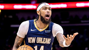 Dec 5, 2024; New Orleans, Louisiana, USA;  New Orleans Pelicans forward Brandon Ingram (14) reacts to a play against Phoenix Suns guard Devin Booker (1) during the first half at Smoothie King Center. Mandatory Credit: Stephen Lew-Imagn Images