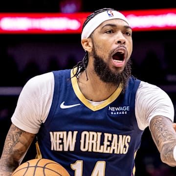Dec 5, 2024; New Orleans, Louisiana, USA;  New Orleans Pelicans forward Brandon Ingram (14) reacts to a play against Phoenix Suns guard Devin Booker (1) during the first half at Smoothie King Center. Mandatory Credit: Stephen Lew-Imagn Images