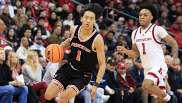 Dec 21, 2024; Newark, New Jersey, USA; Princeton Tigers guard Xaivian Lee (1) dribbles up the court past Rutgers Scarlet Knights guard Jamichael Davis (1) during the second half at Prudential Center. Mandatory Credit: Tom Horak-Imagn Images