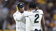 Oct 7, 2023; Tempe, Arizona, USA; Colorado Buffaloes head coach Deion Sanders with son and quarterback Shedeur Sanders (2) against the Arizona State Sun Devils at Mountain America Stadium. Mandatory Credit: Mark J. Rebilas-Imagn Images