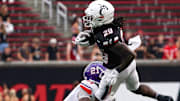 Northwestern State Demons cornerback Ja'Marion Bonner (21) tackles Cincinnati Bearcats running back Manny Covey in the fourth quarter of a NCAA men’s college football game between the Cincinnati Bearcats and Northwestern State Demons, Saturday, Sept. 13, 2025, at Nippert Stadium in Cincinnati. Bearcats won 70-0.