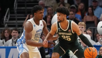 March 23, 2024, Charlotte, NC, USA; Michigan State Spartans forward Malik Hall (25) dribbles against North Carolina Tar Heels forward Harrison Ingram (55)  in the second round of the 2024 NCAA Tournament at the Spectrum Center. Mandatory Credit: Jim Dedmon-USA TODAY Sports