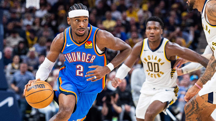 Oct 23, 2025; Indianapolis, Indiana, USA;  Oklahoma City Thunder guard Shai Gilgeous-Alexander (2) dribbles the ball while Indiana Pacers guard Bennedict Mathurin (00) defends in the second half at Gainbridge Fieldhouse. Mandatory Credit: Trevor Ruszkowski-Imagn Images