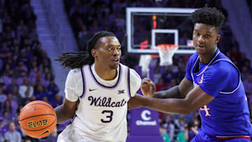 Feb 8, 2025; Manhattan, Kansas, USA; Kansas State Wildcats guard C.J. Jones (3) dribbles against Kansas Jayhawks forward K.J. Adams (24) during the first half at Bramlage Coliseum. Mandatory Credit: Scott Sewell-Imagn Images