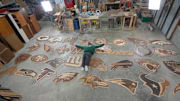 Artist Ike Wynter lays among his many creations for the 2025 draft.