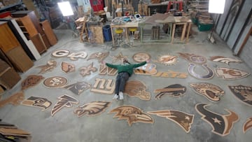 Artist Ike Wynter lays among his many creations for the 2025 draft.