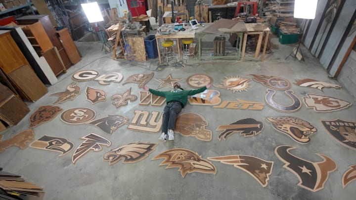 Artist Ike Wynter lays among his many creations for the 2025 draft. Artist Ike Wynter lays among his many creations for the 2025 draft.