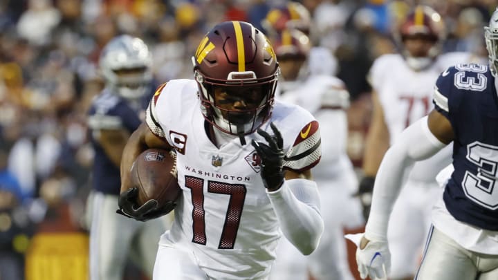 Jan 8, 2023; Landover, Maryland, USA; Washington Commanders wide receiver Terry McLaurin (17) runs with the ball for a touchdown as Dallas Cowboys linebacker Damone Clark (33) chases during the first quarter at FedExField. Mandatory Credit: Geoff Burke-USA TODAY Sports