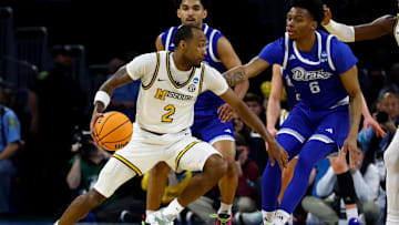 Mar 20, 2025; Wichita, KS, USA; Missouri Tigers guard Tamar Bates (2) dribbles against Drake Bulldogs guard Tavion Banks (6) in the second half of a first round men’s NCAA Tournament game at Intrust Bank Arena. Mandatory Credit: Nick Tre. Smith-Imagn Images
