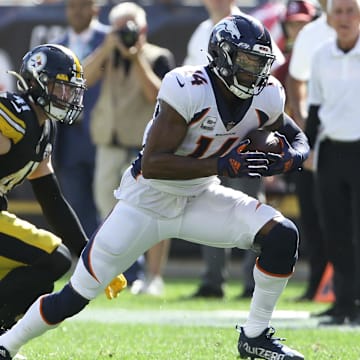 Oct 10, 2021; Pittsburgh, Pennsylvania, USA;  Denver Broncos wide receiver Courtland Sutton (14) runs after a catch as Pittsburgh Steelers inside linebacker Robert Spillane (41) defends during the second quarter at Heinz Field. 