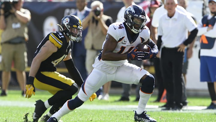 Oct 10, 2021; Pittsburgh, Pennsylvania, USA;  Denver Broncos wide receiver Courtland Sutton (14) runs after a catch as Pittsburgh Steelers inside linebacker Robert Spillane (41) defends during the second quarter at Heinz Field. 