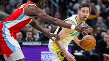 Feb 20, 2025; Indianapolis, Indiana, USA; Indiana Pacers guard T.J. McConnell (9) dribbles the ball while Memphis Grizzlies guard Vince Williams Jr. (5) defends in the second half at Gainbridge Fieldhouse. Mandatory Credit: Trevor Ruszkowski-Imagn Images