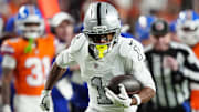 Nov 6, 2025; Denver, Colorado, USA; Las Vegas Raiders wide receiver Tre Tucker (1) runs with the ball after catch against the Denver Broncos during the first half at Empower Field at Mile High. 