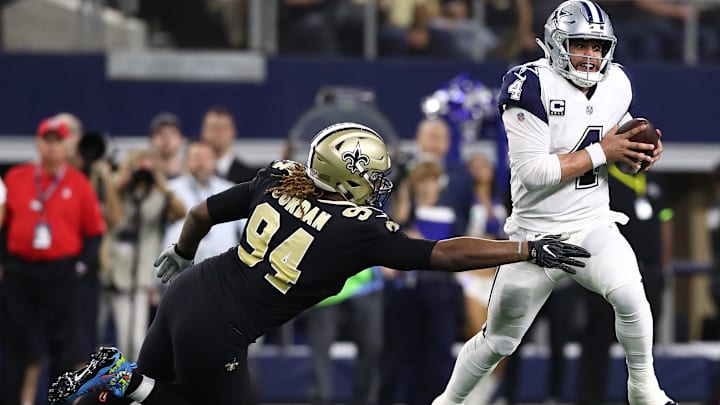 Dallas Cowboys quarterback Dak Prescott (4) runs under pressure from New Orleans Saints defensive end Cameron Jordan (94)