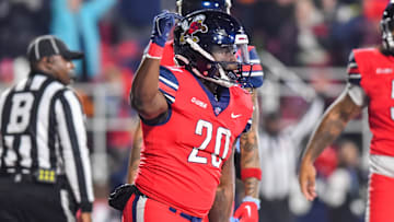 Dec 1, 2023; Lynchburg, VA, USA; Liberty Flames running back Quinton Cooley (20) celebrates a touchdown against the New Mexico State Aggies at Williams Stadium.