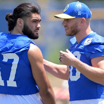 May 28, 2024; Thousand Oaks, CA, USA; Los Angeles Rams wide receiver Puka Nacua (17) and wide receiver Cooper Kupp (10) talk during OTAs at California Lutheran University. Mandatory Credit: Jayne Kamin-Oncea-Imagn Images