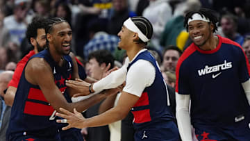 Mar 15, 2025; Denver, Colorado, USA; Washington Wizards guard Jordan Poole (13) (center) celebrates with teammates following his three-point basket in the fourth quarter against the Denver Nuggets at Ball Arena. Mandatory Credit: Ron Chenoy-Imagn Images