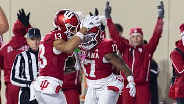 Nov 30, 2024; Bloomington, Indiana, USA; Indiana Hoosiers running back Ty Son Lawton (17) scores a touchdown and celebrates with teammates  in the first half against the Purdue Boilermakers at Memorial Stadium. Mandatory Credit: Trevor Ruszkowski-Imagn Images