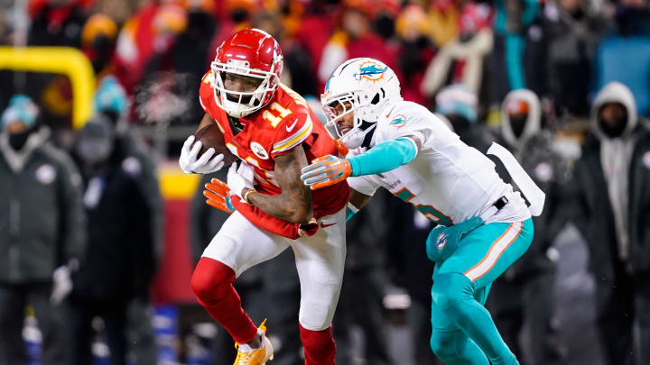 Jan 13, 2024; Kansas City, MO; Kansas City Chiefs wide receiver Marquez Valdes-Scantling (11) runs with the ball against Miami Dolphins cornerback Jalen Ramsey (5) during the first half of a 2024 AFC wild card game at GEHA Field at Arrowhead Stadium.