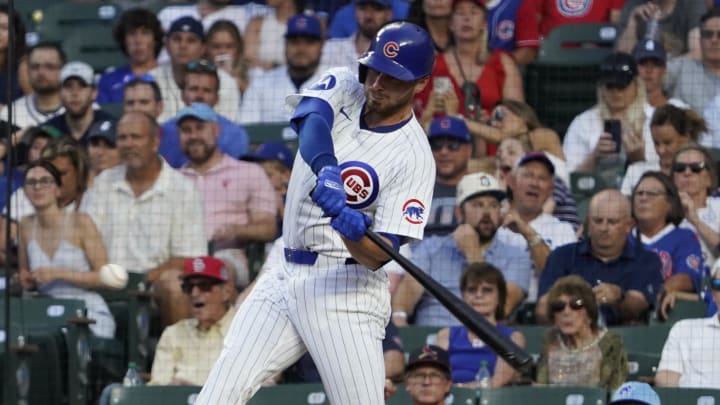 Aug 4, 2024; Chicago, Illinois, USA; Chicago Cubs first base Michael Busch (29) hits a single against the St. Louis Cardinals during the fifth inning at Wrigley Field.