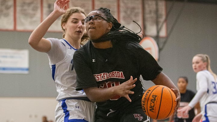 Amani Bartholomew (30) drives to the hoop during the Pace vs West Florida girls basketball game at West Florida High School in Pensacola on Tuesday, Dec. 3, 2024. Amani Bartholomew (30) drives to the hoop during the Pace vs West Florida girls basketball game at West Florida High School in Pensacola on Tuesday, Dec. 3, 2024.