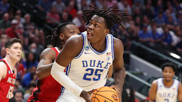 Mar 31, 2024; Dallas, TX, USA; Duke Blue Devils forward Mark Mitchell (25) controls the ball against North Carolina State Wolfpack guard DJ Horne (0) in the first half in the finals of the South Regional of the 2024 NCAA Tournament at American Airline Center. Mandatory Credit: Kevin Jairaj-USA TODAY Sports