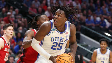 Mar 31, 2024; Dallas, TX, USA; Duke Blue Devils forward Mark Mitchell (25) controls the ball against North Carolina State Wolfpack guard DJ Horne (0) in the first half in the finals of the South Regional of the 2024 NCAA Tournament at American Airline Center. Mandatory Credit: Kevin Jairaj-USA TODAY Sports