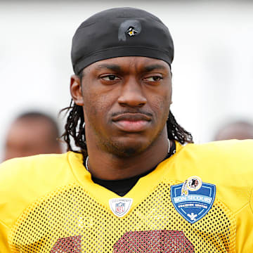 Washington Redskins quarterback Robert Griffin III (10) looks on prior to joint practice with the Houston Texans as part of day eight of training camp at Bon Secours Washington Redskins Training Center. Mandatory Credit: Amber Searls-Imagn Images