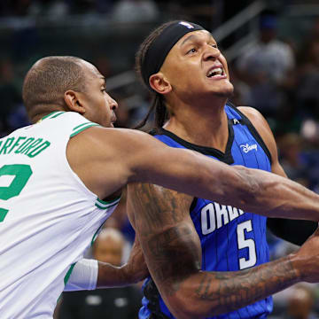 Orlando Magic forward Paolo Banchero is fouled by Boston Celtics center Al Horford.