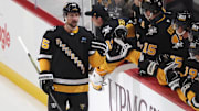 Apr 8, 2025; Pittsburgh, Pennsylvania, USA;  Pittsburgh Penguins defenseman Erik Karlsson (65) celebrates his 200th career NHL goal with the Penguins bench against the Chicago Blackhawks during the second period at PPG Paints Arena. Mandatory Credit: Charles LeClaire-Imagn Images