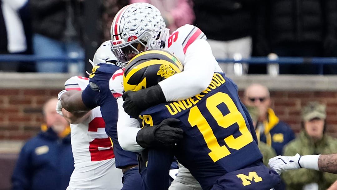 Ohio State Buckeyes defensive end Kenyatta Jackson Jr. (97) tackles Michigan Wolverines quarterback Bryce Underwood (19)