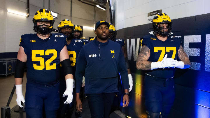 Jan 8, 2024; Houston, TX, USA; Michigan Wolverines offensive coordinator Sherrone Moore with offensive lineman Karsen Barnhart (52) and Trevor Keegan (77) against the Washington Huskies during the 2024 College Football Playoff national championship game at NRG Stadium. Mandatory Credit: Mark J. Rebilas-USA TODAY Sports