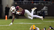 Oct 24, 2025; Blacksburg, Va.; Virginia Tech running back Marcellous Hawkins (27) goes airborne after a hit.