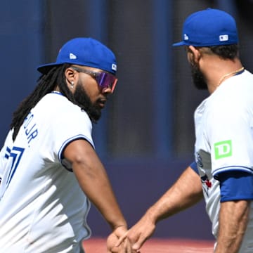 Toronto Blue Jays first baseman Vladimir Guerrero Jr. (27) slaps hands with relief pitcher Yimi Garcia (93) after a win over the Baltimore Orioles at Rogers Centre on June 6.