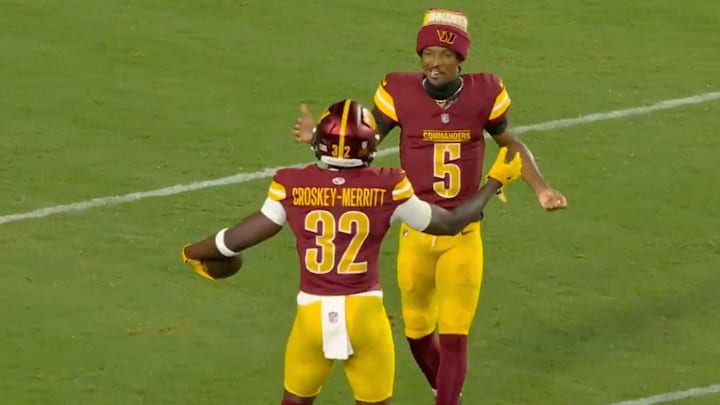 Washington Commanders running back Jacory Croskey-Merritt celebrates with Jayden Daniels after a touchdown run.