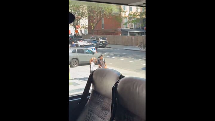 A young kid makes a heart with his hands that's directed toward NBA draft prospects on June 25, 2025.