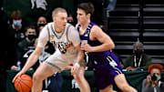 Jan 15, 2022; East Lansing, Michigan, USA;  Michigan State Spartans forward Joey Hauser (10) moves the ball against Northwestern Wildcats guard Ryan Greer (2) in the first half  at Jack Breslin Student Events Center. Mandatory Credit: Dale Young-Imagn Images