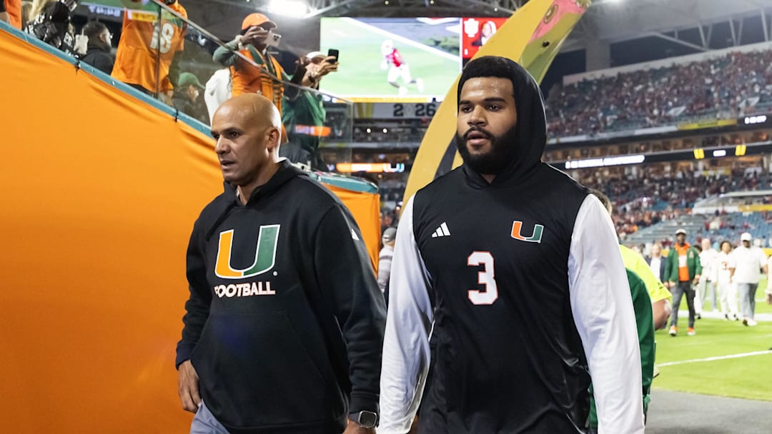 Jan 19, 2026; Miami Gardens, FL, USA; Miami Hurricanes defensive lineman Akheem Mesidor (3) with coach Jason Taylor against the Indiana Hoosiers during the College Football Playoff National Championship game at Hard Rock Stadium. Mandatory Credit: Mark J. Rebilas-Imagn Images