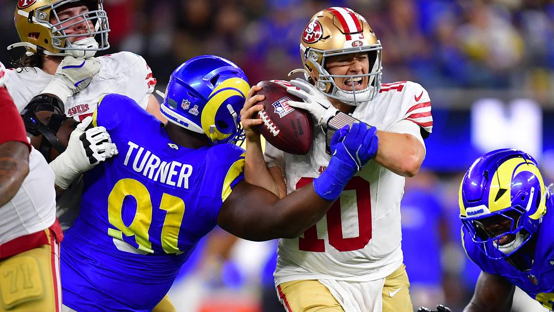 Oct 2, 2025; Inglewood, California, USA; Los Angeles Rams defensive end Kobie Turner (91) sacks San Francisco 49ers quarterback Mac Jones (10) during overtime at SoFi Stadium. Mandatory Credit: Gary A. Vasquez-Imagn Images
