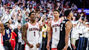 Arizona Wildcats guard Caleb Love (1) celebrates the win while Iowa State Cyclones forward Joshua Jefferson (2) leaves the court at the end of overtime at McKale Center. 
