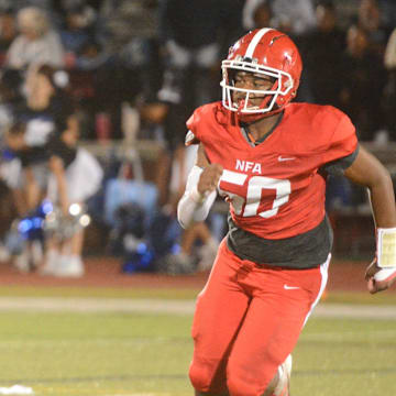 NFA lineman Jasiyah Succes (50) forces Bunnell quarterback Steven Mendoza from the pocket.